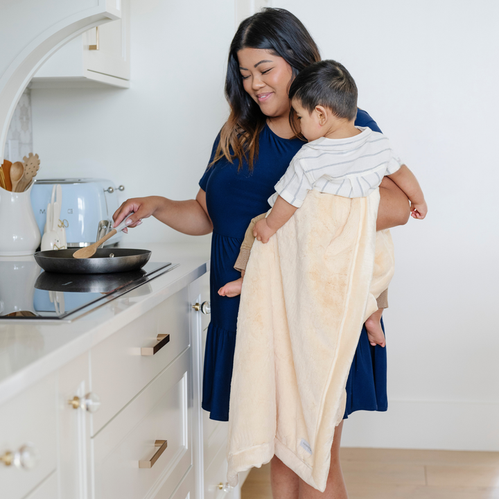 Infants stay snug in the Chiffon Saranoni Lush Receiving Blanket, a soft newborn receiving blanket.