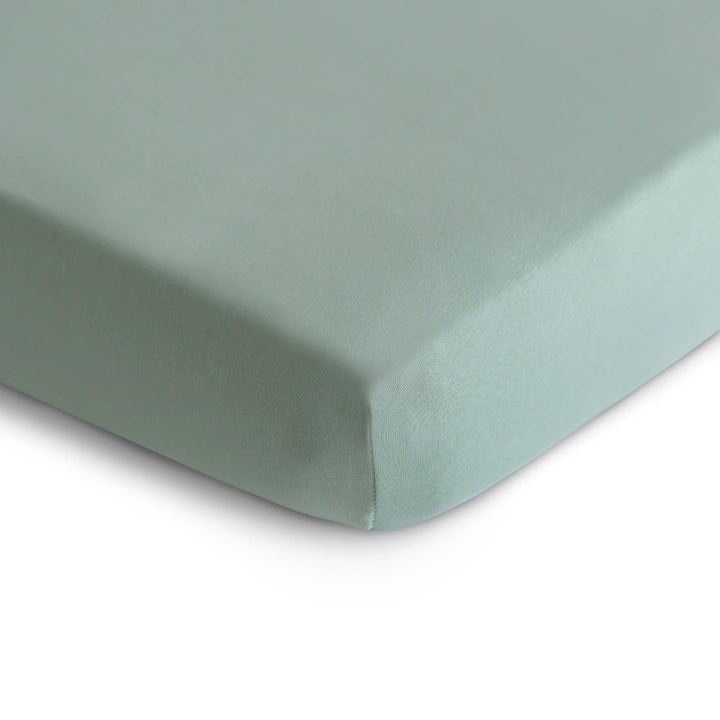 Mushie stretchy crib sheet in Roman Green color for a calming nursery look