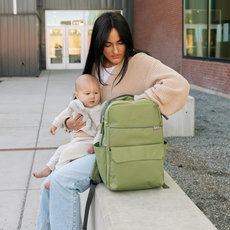 Shown open, the Little Unicorn Red Rovr Roo Backpack - Moss provides ample space, ideal for organizing kids school backpacks.