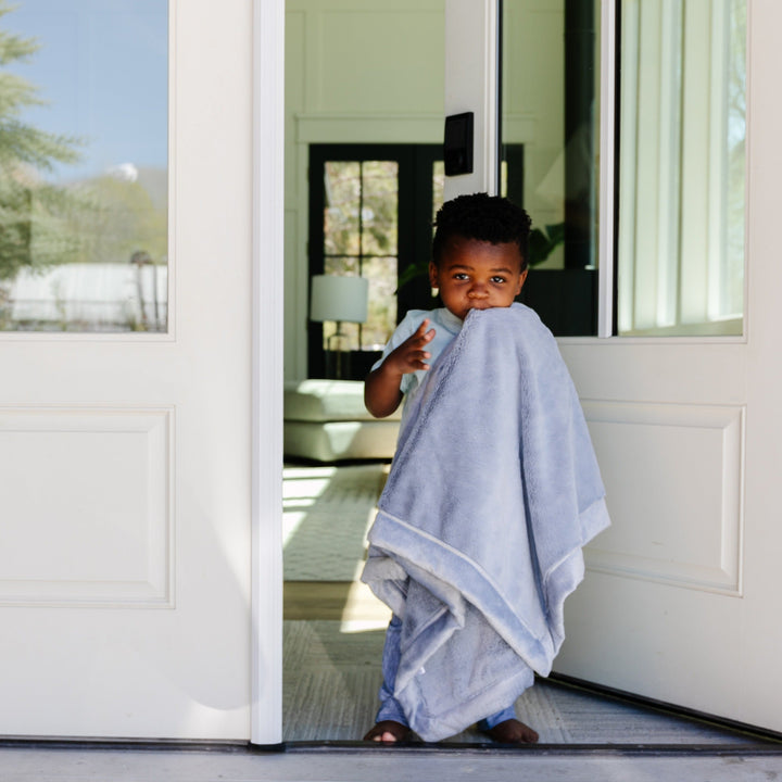 The Storm Cloud Lush Receiving Blanket by Saranoni adds warmth and softness, a must-have among receiving blankets.