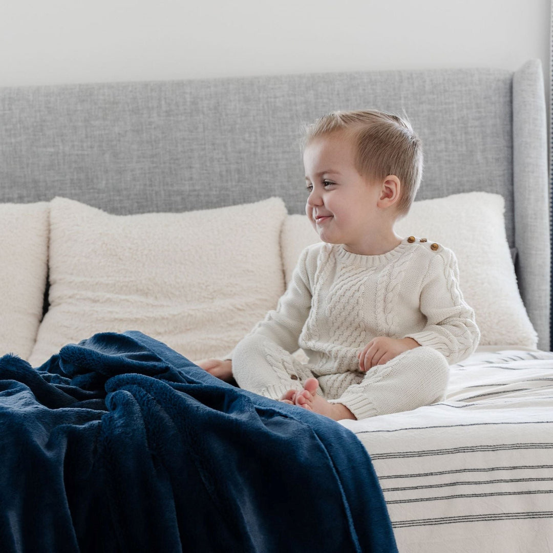 The Navy Lush Receiving Blanket from Saranoni adds warmth, a soft best baby blankets pick.