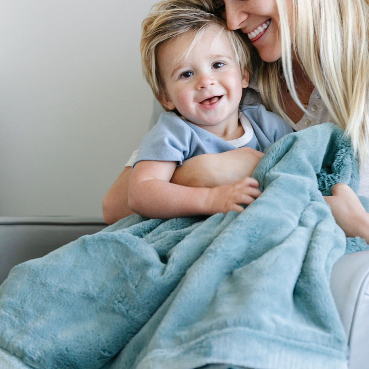 Cuddle your baby with the Dew Saranoni Lush Receiving Blanket, an ideal baby receiving blankets option.