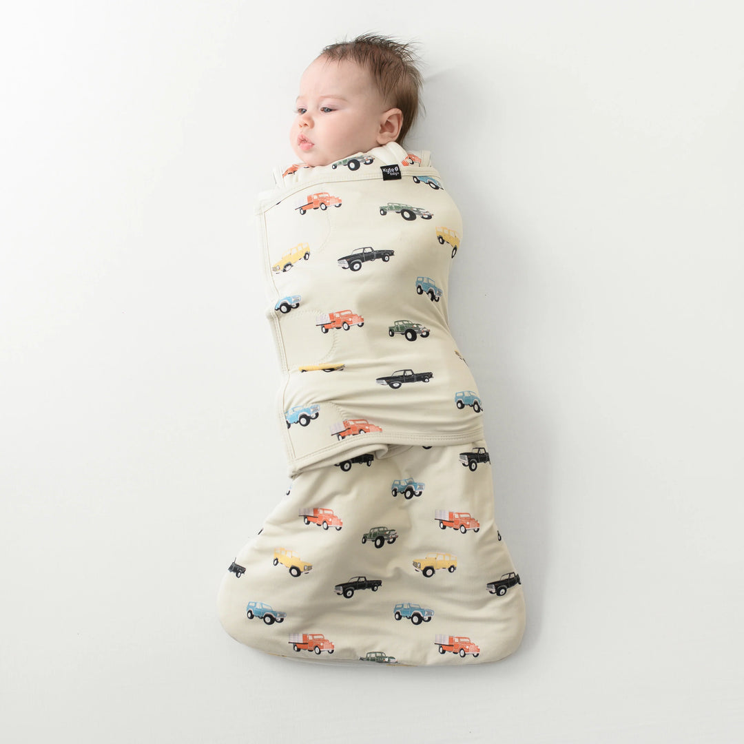 Perfect for tiny sleepers, Kyte Baby Baby Sleep Sack Swaddler XS in Vintage Truck features bamboo softness in a newborn sleep sack