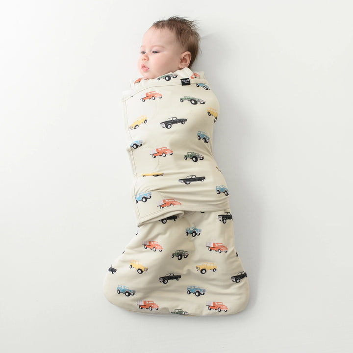 Perfect for tiny sleepers, Kyte Baby Baby Sleep Sack Swaddler XS in Vintage Truck features bamboo softness in a newborn sleep sack
