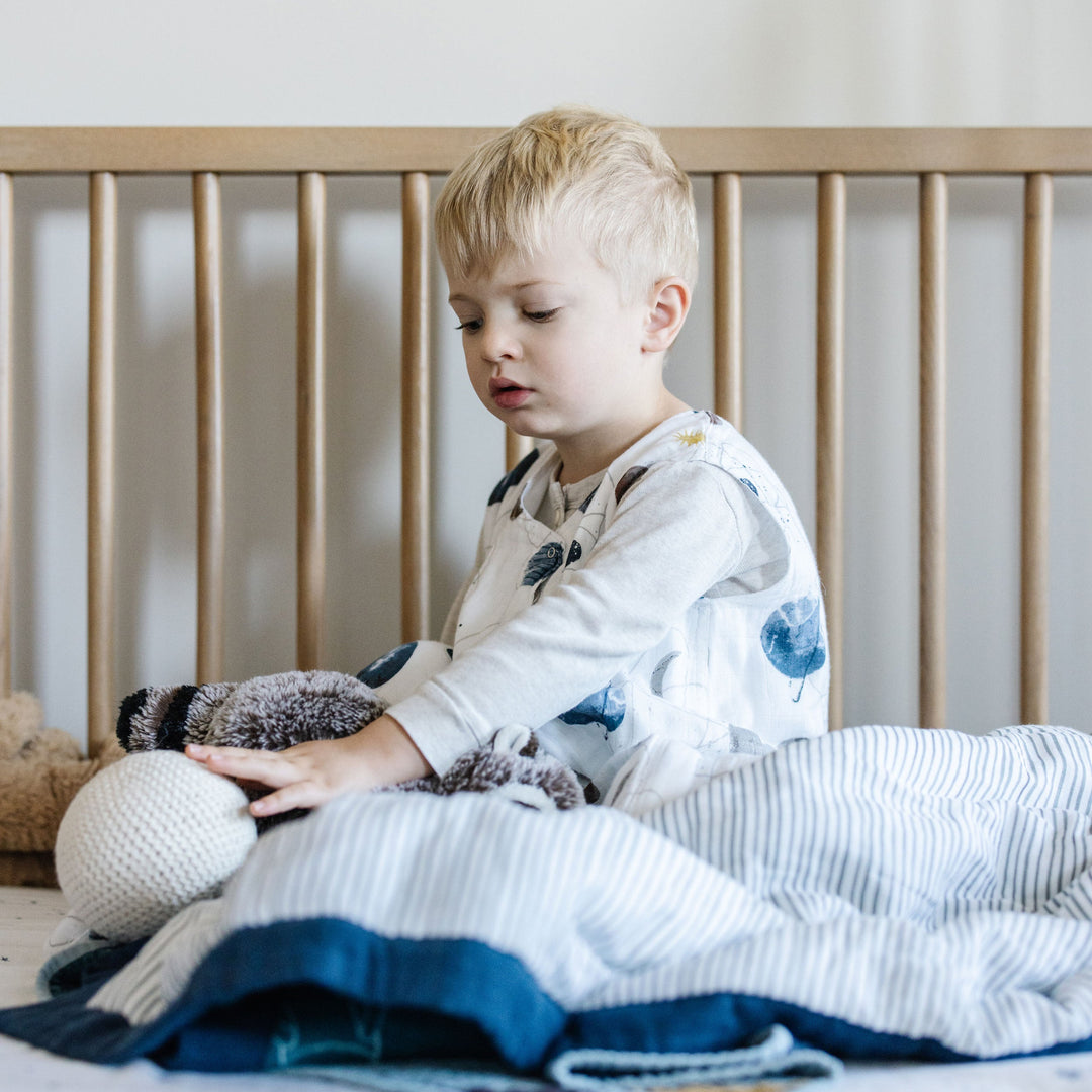 Little Unicorn Cotton Muslin Sleep Bag - Planetary displayed with celestial print, ideal sleep bags for babies.