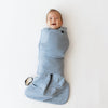 Baby laughing in slate blue sleep bag swaddler from Kyte