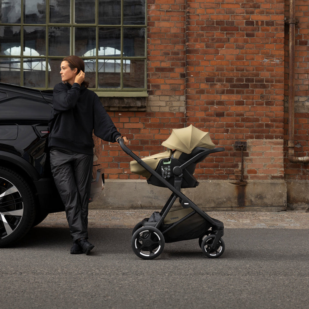 Lifestyle image of the Thule Charm Stroller | reversible seat stroller