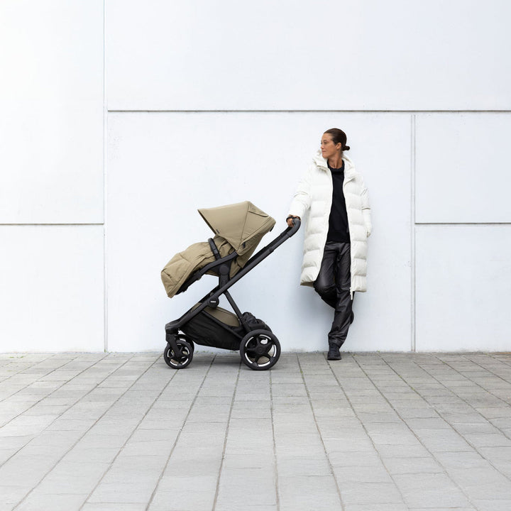 Lifestyle image of the Thule Charm Stroller with Thule Elements footmuff | stroller w/ newborn insert
