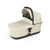 Soft beige Thule baby bassinet, providing comfort and convenience for parents.