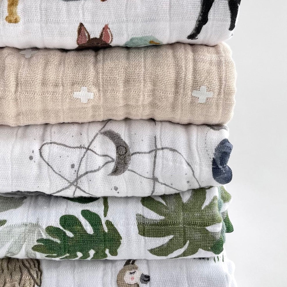 Stack of Little Unicorn Original Cotton Muslin Quilt - Tropical Leaf and others, showcasing a premium selection of handmade quilts.