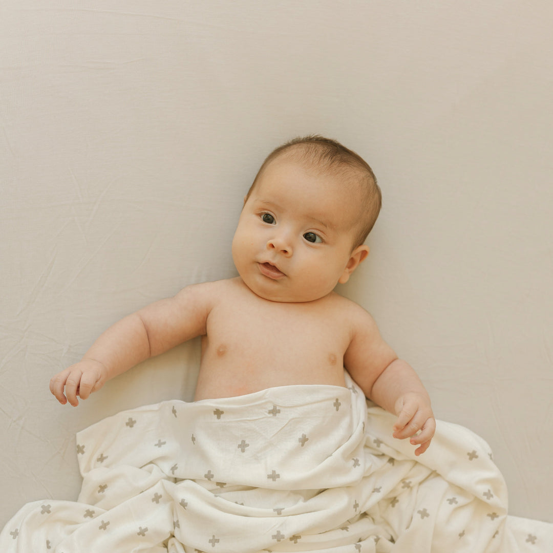 Little Unicorn Pebble Stretch Knit Crib Sheet paired with baby accessories, premium baby crib sheets for everyday use