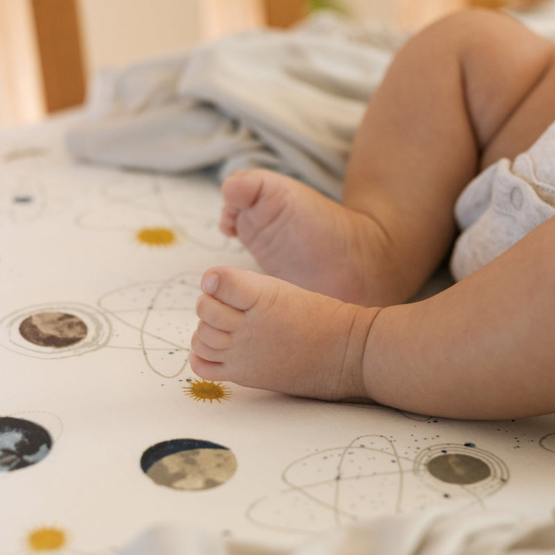 Stretch Knit Crib Sheet by Little Unicorn in Planets, one of the best crib sheets with soft and breathable fabric.