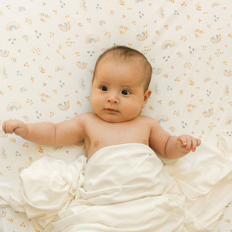 Organic cotton Little Unicorn Stretch Knit Crib Sheet in Rainbows, perfect mattress sheets for crib with playful design.