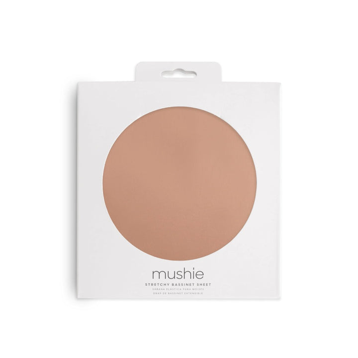 Natural-colored crib sheet neatly folded and packaged in a box ready for baby's crib