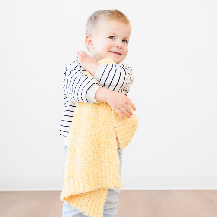 SaranoniÕs BAMBONI¨ Mini Blanket in Sunburst offers irresistible comfort, making it one of the best baby blankets for every season.