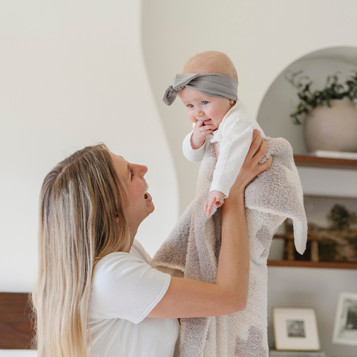 Wrap your little one in the Saranoni BAMBONI¨ Receiving Blanket, Swiss Cross design, a luxuriously soft baby blanket.