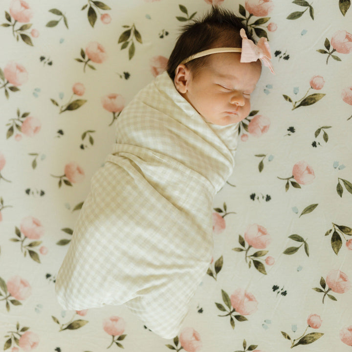 Soft and breathable muslin for swaddling, Little Unicorn Stretch Knit Tan Gingham Swaddle Blanket.
