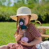 toddler holding indigo rose tritan bottle in sunhat outside