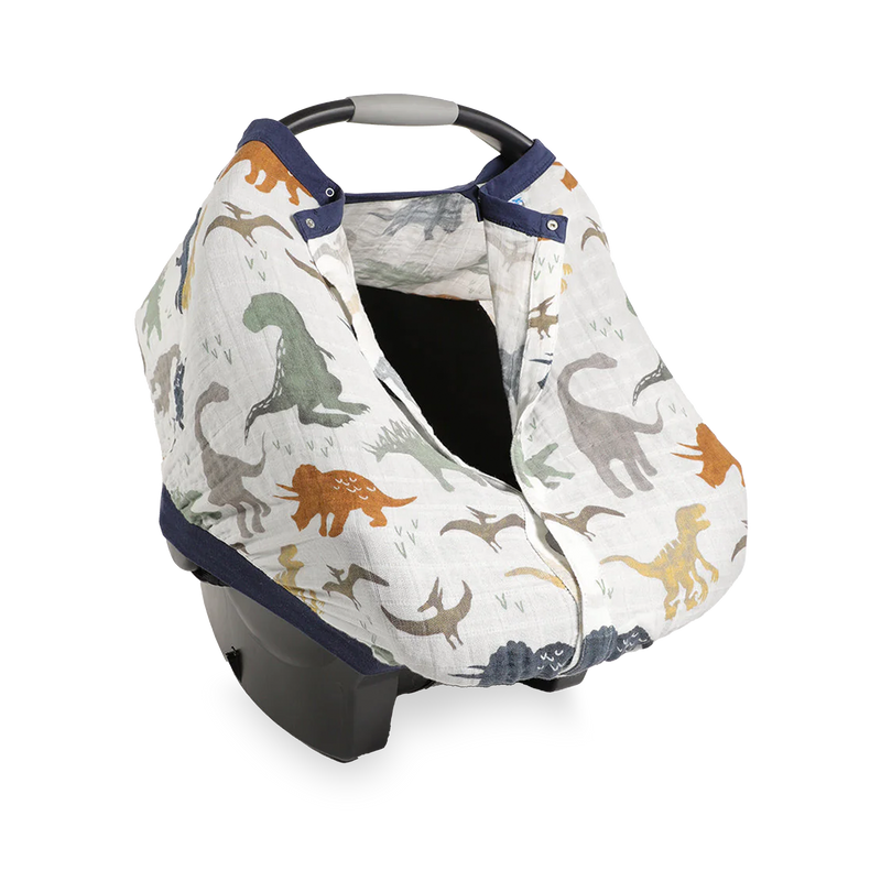 Close-up of the Little Unicorn Cotton Muslin Car Seat Canopy - Dino Friends highlighting soft, breathable fabric for baby car seat comfort.