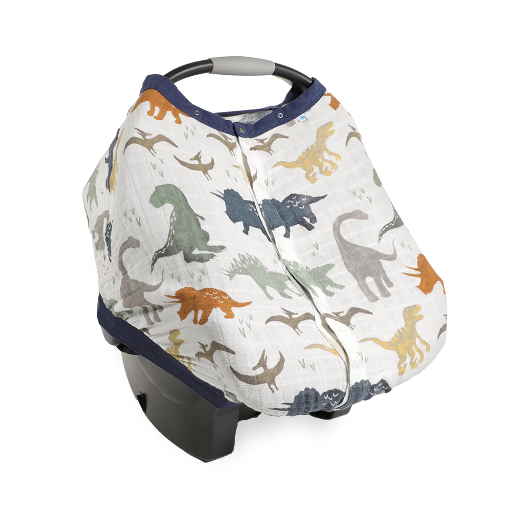 Little Unicorn Cotton Muslin Car Seat Canopy - Dino Friends shown in a playful dinosaur print, perfect for stylish car seat canopy protection.