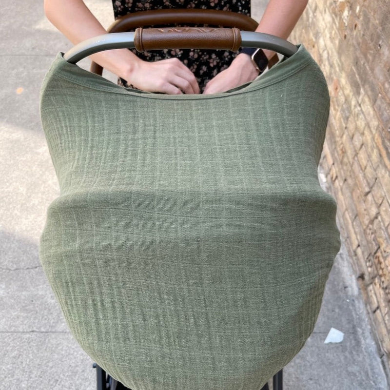 Little Unicorn Cotton Muslin Car Seat Canopy - Fern displayed on a car seat, combining comfort and natural style for daily use.