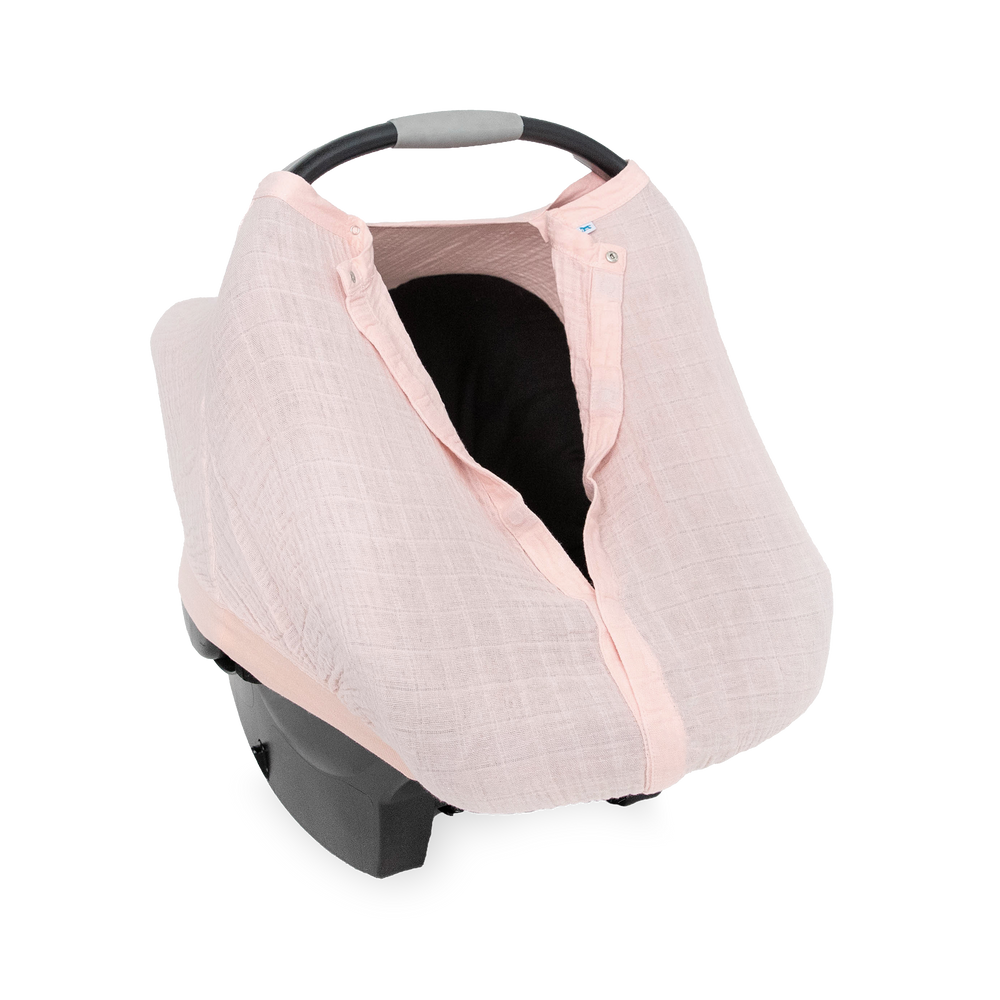 Close-up of the Little Unicorn Cotton Muslin Car Seat Canopy - Light Pink highlighting breathable muslin fabric for baby car seat comfort.