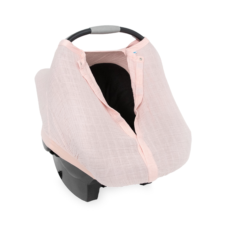 Close-up of the Little Unicorn Cotton Muslin Car Seat Canopy - Light Pink highlighting breathable muslin fabric for baby car seat comfort.
