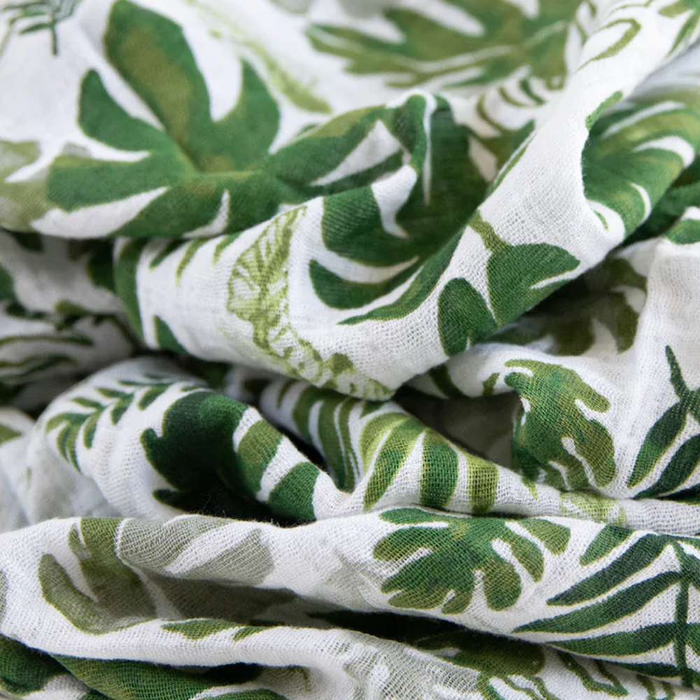 Tropical Leaf muslin swaddle by Little Unicorn, perfect for gentle infant swaddling and cozy sleep.