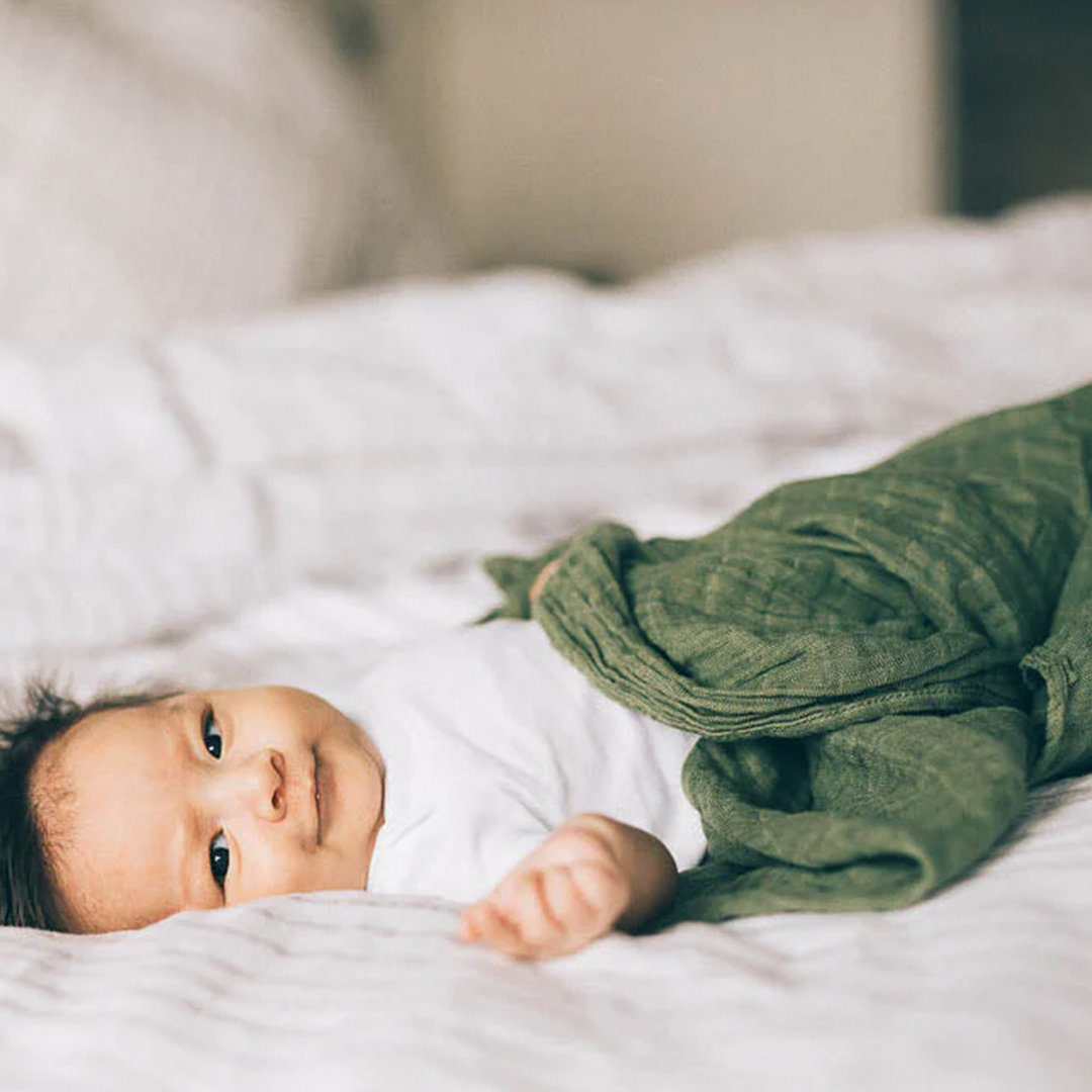 Infant muslin blankets by Little Unicorn in Fern, ideal for gentle swaddling.