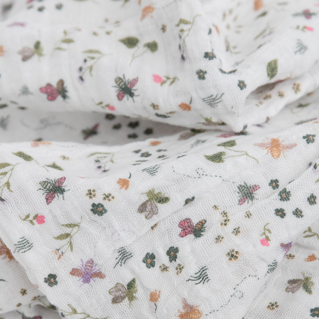 Cozy Little Unicorn Garden Bees muslin swaddle blanket, perfect for gentle swaddling.