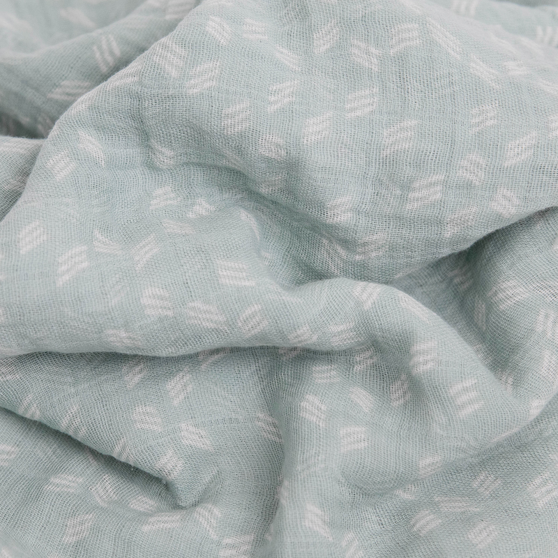 Little Unicorn’s Cotton Muslin Swaddle Blanket in Misty Field, perfect for infant swaddling.