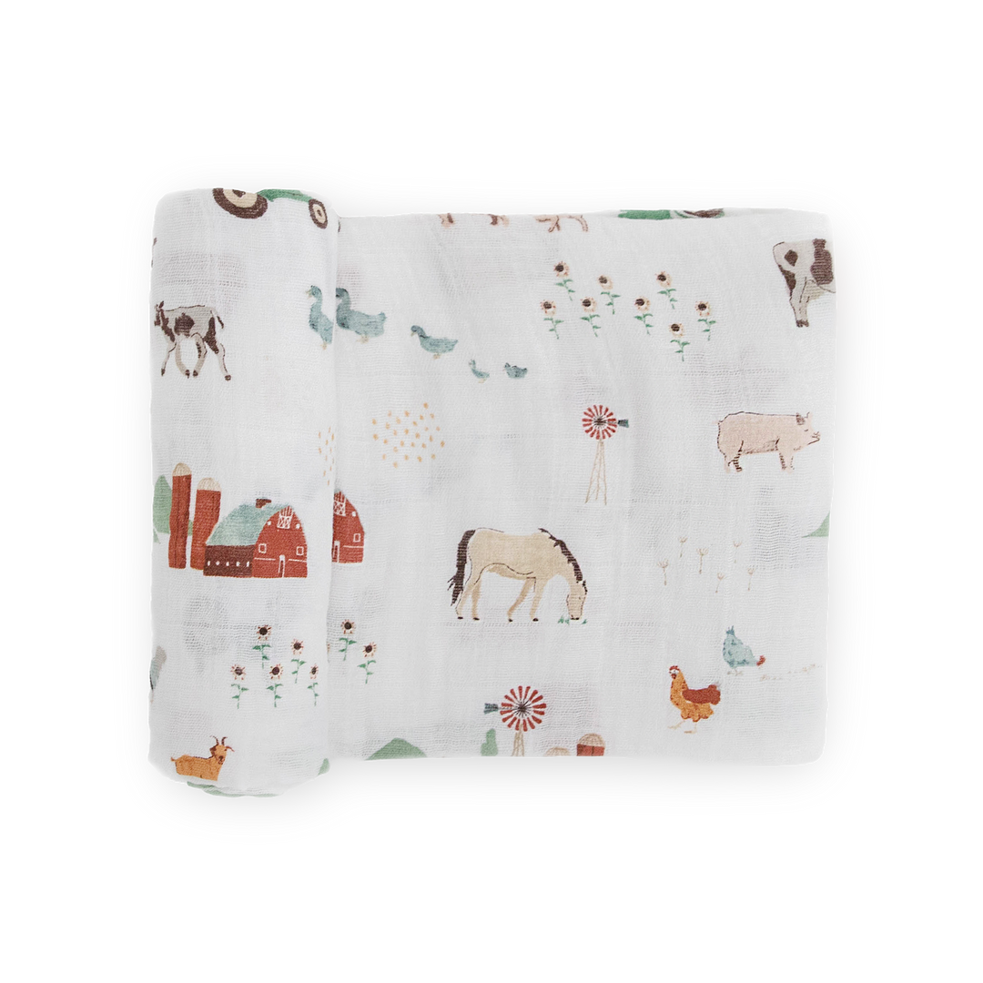 Little Unicorn Cotton Muslin Swaddle Blanket – Farmyard featuring soft muslin for swaddling newborns.