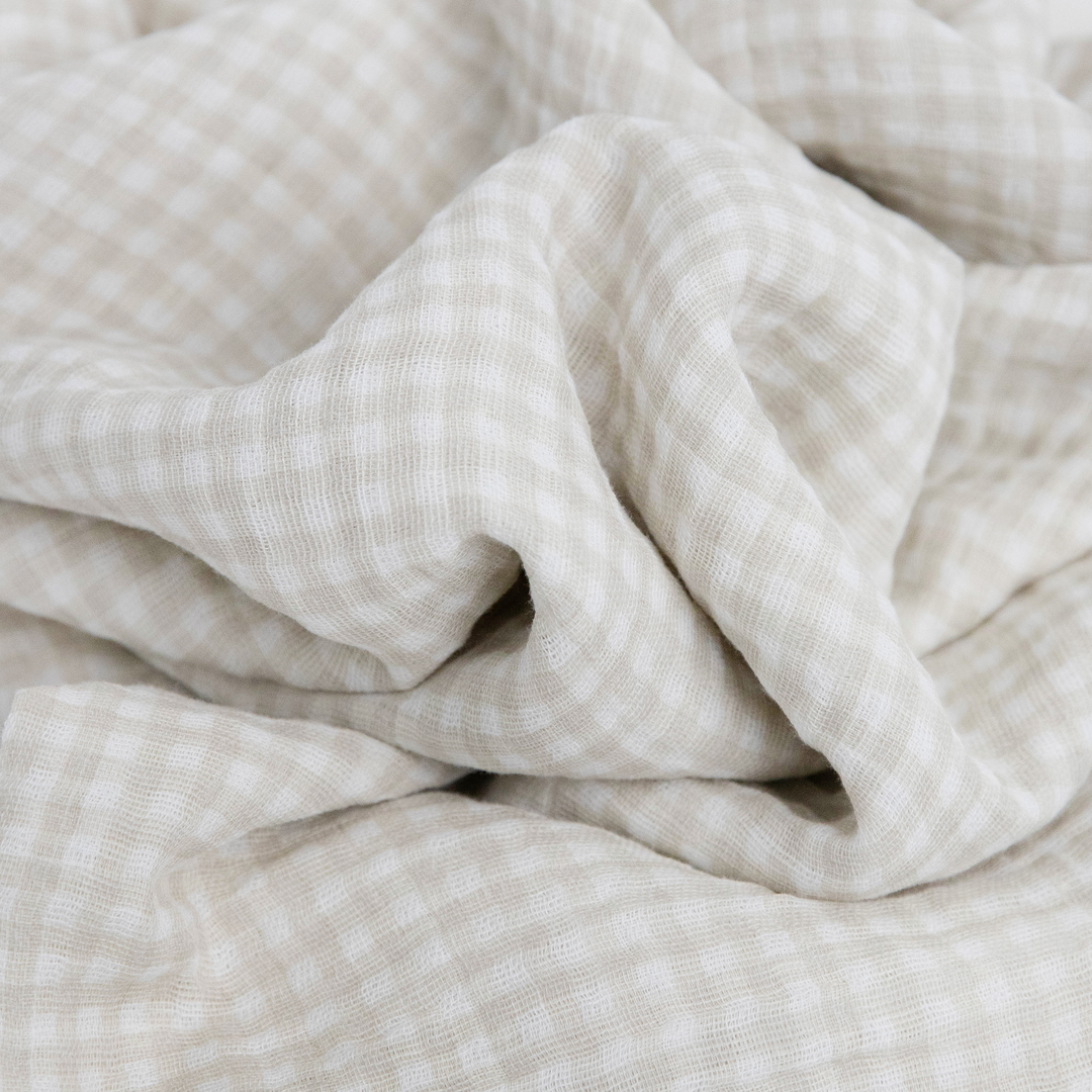 Cozy Tan Gingham muslin blankets by Little Unicorn, ideal for newborn swaddling.