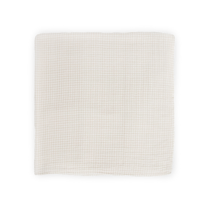 Wrap your baby in comfort with this Little Unicorn muslin swaddle in Tan Gingham print.