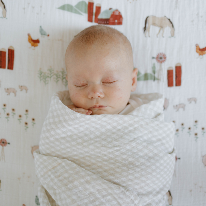 Little Unicorn muslin baby blankets in Tan Gingham, cozy for naps and swaddling.