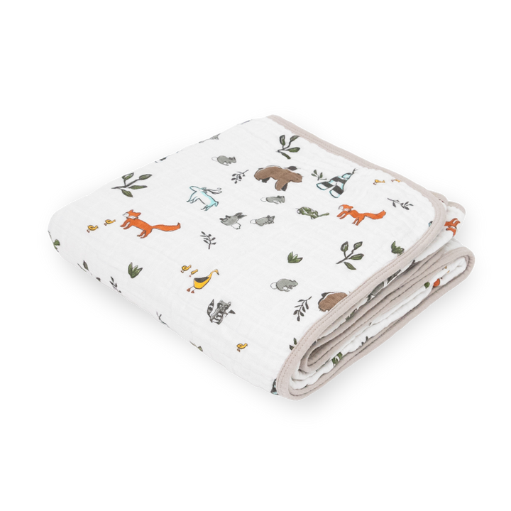 Little Unicorn Original Cotton Muslin Quilt - Forest Friends neatly folded, a cozy baby blanket with soft woodland-inspired prints.
