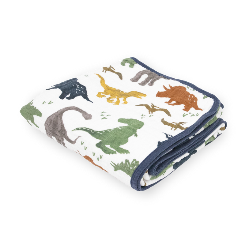 Little Unicorn Original Cotton Muslin Quilt - Dino Friends neatly folded, a soft and cozy baby blanket featuring playful dinosaur prints.