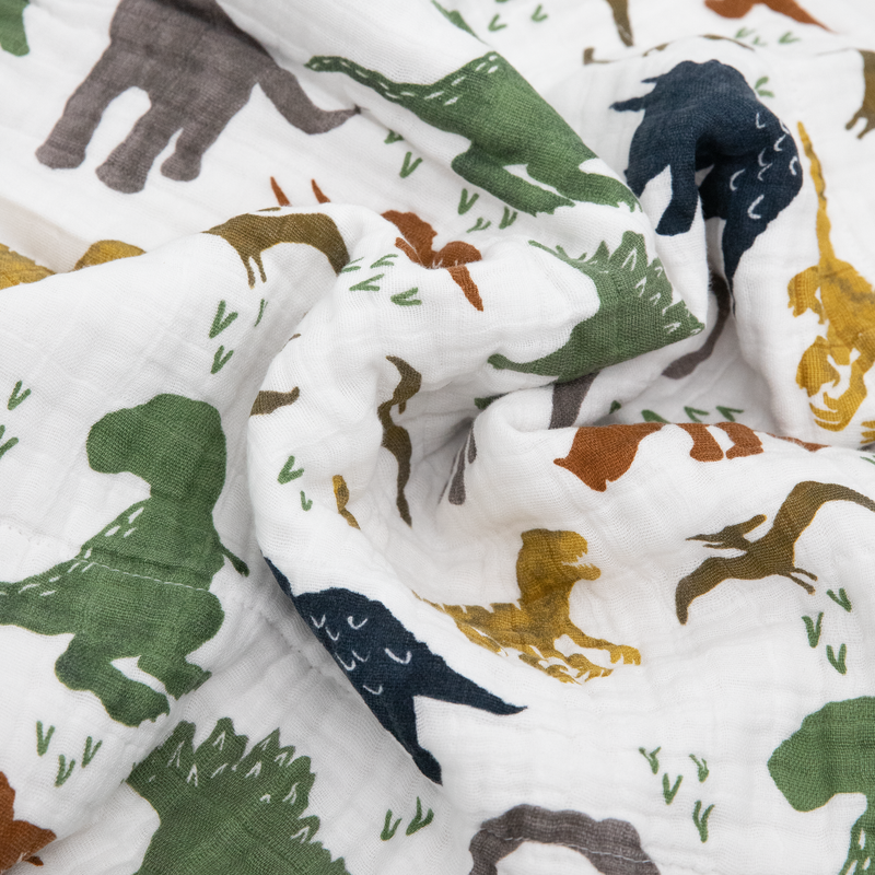 Beautifully detailed Little Unicorn Original Cotton Muslin Quilt - Dino Friends, crafted for comfort with a colorful muslin quilt design.