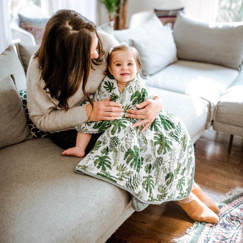 Little Unicorn Original Cotton Muslin Quilt - Tropical Leaf folded with texture detail, highlighting the softness of this cotton quilt.