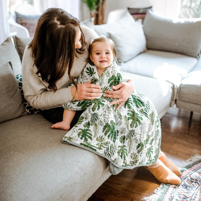 Little Unicorn Original Cotton Muslin Quilt - Tropical Leaf folded with texture detail, highlighting the softness of this cotton quilt.