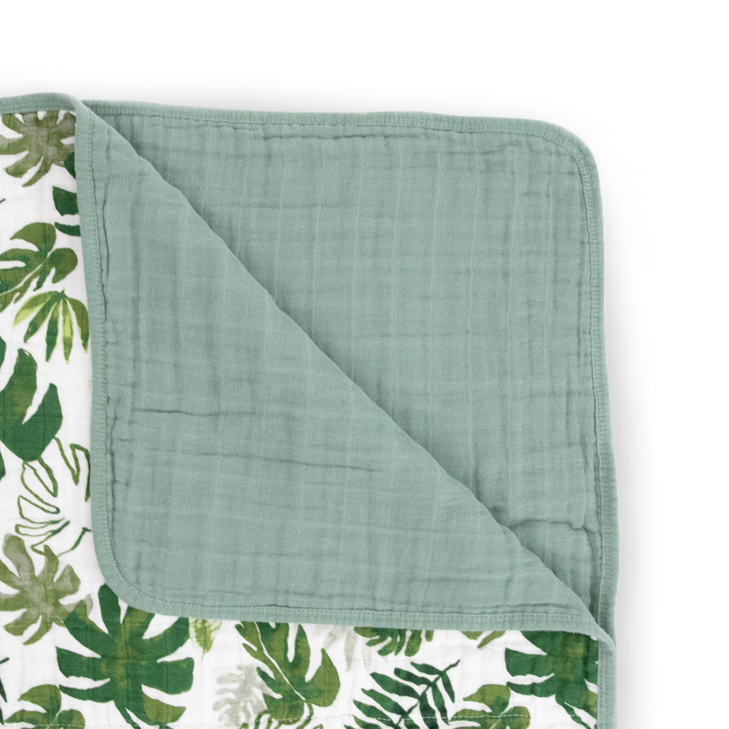 The Little Unicorn Original Cotton Muslin Quilt - Tropical Leaf shown flat, a lightweight muslin blanket perfect for cozy comfort.