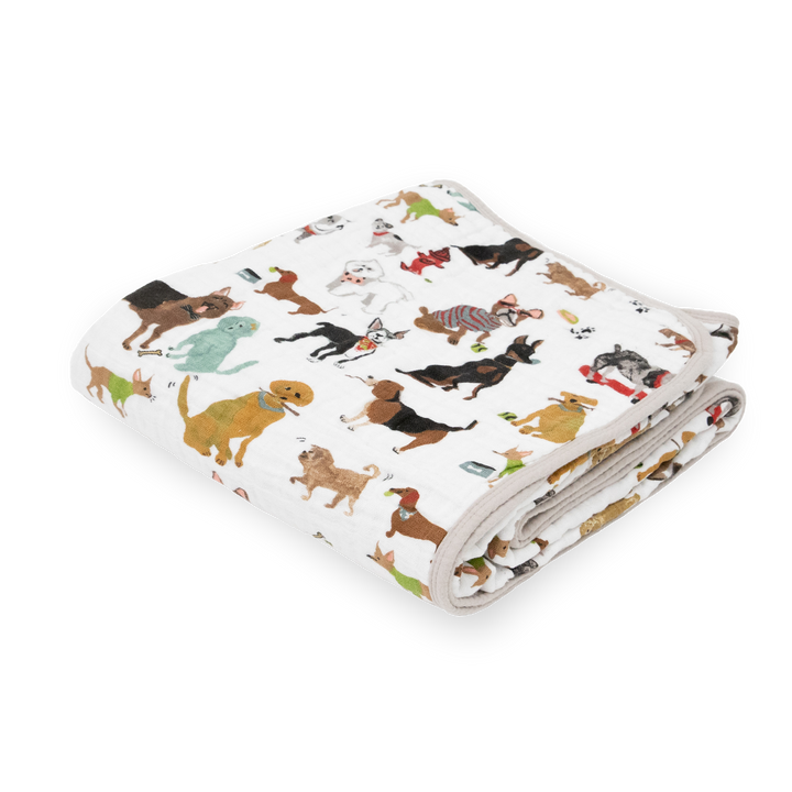 Little Unicorn Original Cotton Muslin Quilt - Woof neatly folded, a cozy baby blanket with playful dog-themed prints.
