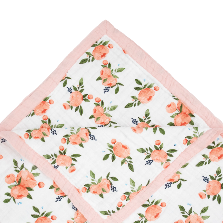 Close-up of Little Unicorn Cotton Muslin Baby Quilt - Watercolor Roses showing breathable muslin layers for gentle baby comfort.