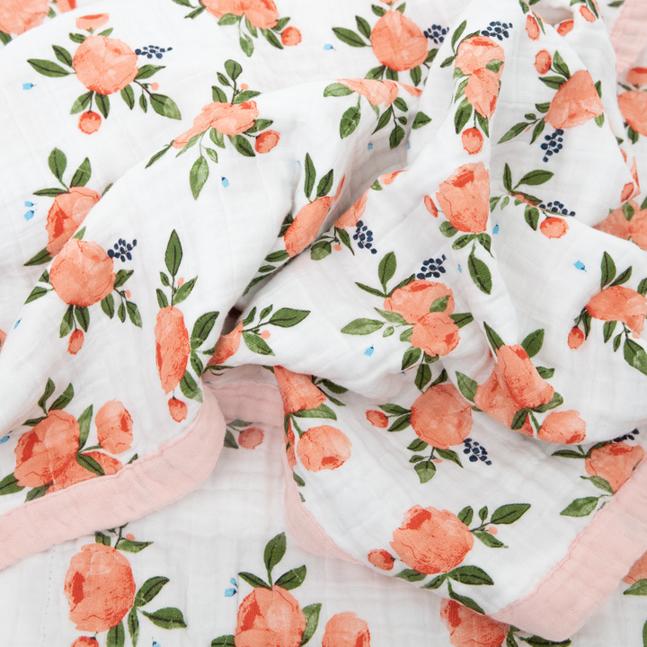 Little Unicorn Cotton Muslin Baby Quilt - Watercolor Roses folded neatly, crafted from lightweight muslin blankets for everyday use.
