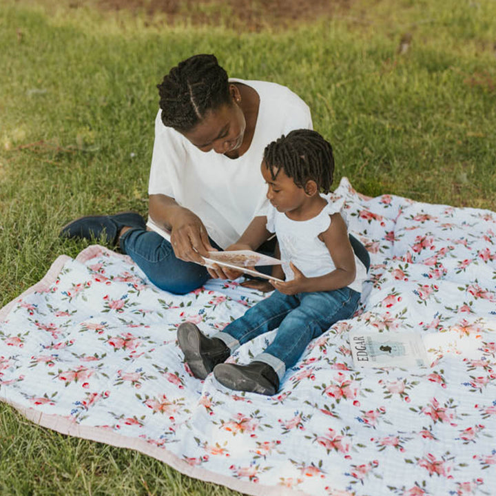 Soft and cozy Little Unicorn Cotton Muslin Baby Quilt - Watercolor Roses with delicate floral prints, ideal as muslin blankets baby.