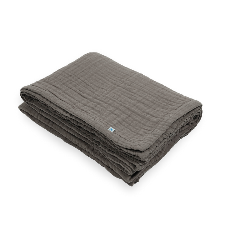 Soft muslin quilt from Little Unicorn, the Cotton Muslin Quilted Throw - Mocha, ideal for naps and cuddles