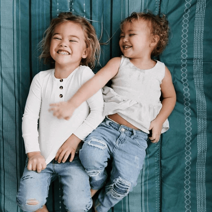 Little Unicorn Outdoor Blanket - Shoreline Stripe displayed on grass, best outdoor blanket for kids and adults