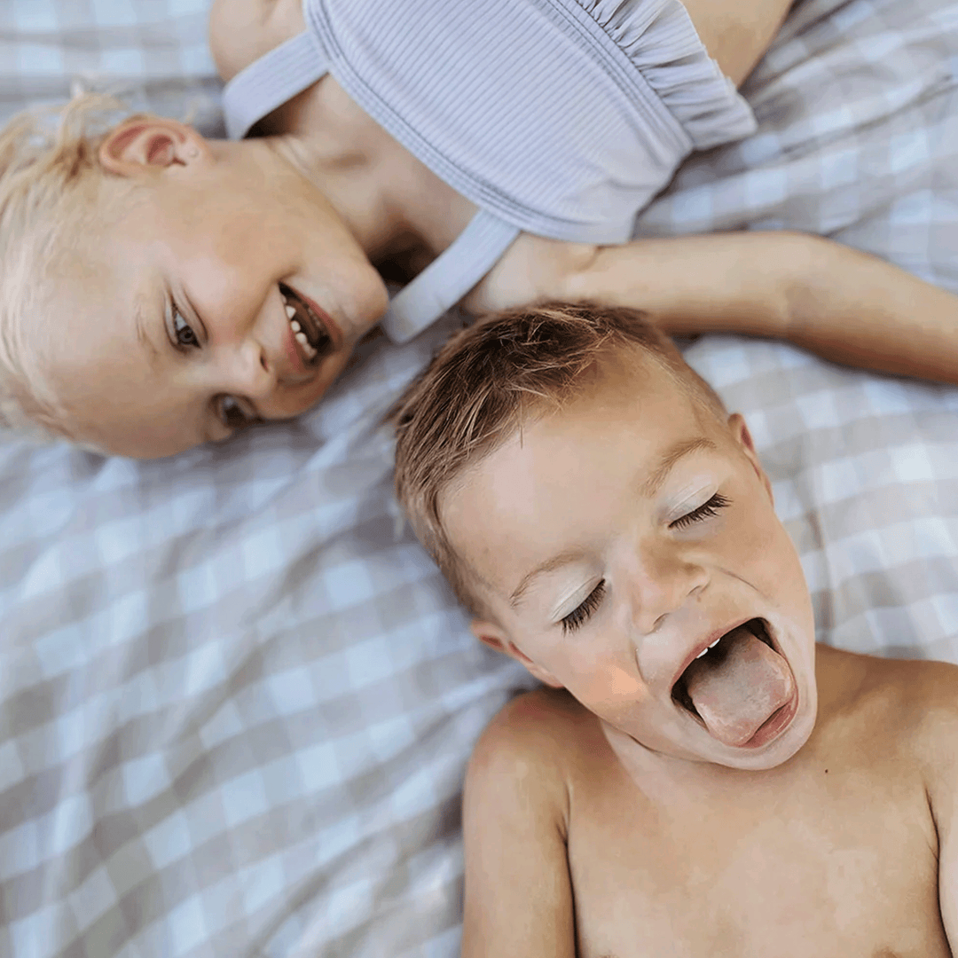 Relax anywhere on the Little Unicorn Beige Buffalo Check Outdoor Blanket, one of the best outdoor blankets available