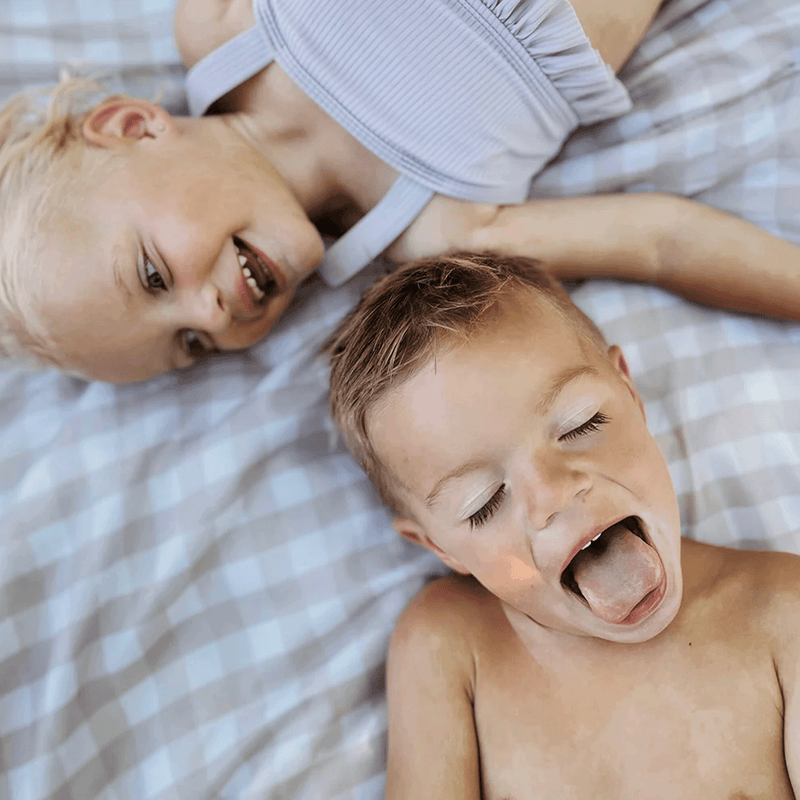 Relax anywhere on the Little Unicorn Beige Buffalo Check Outdoor Blanket, one of the best outdoor blankets available