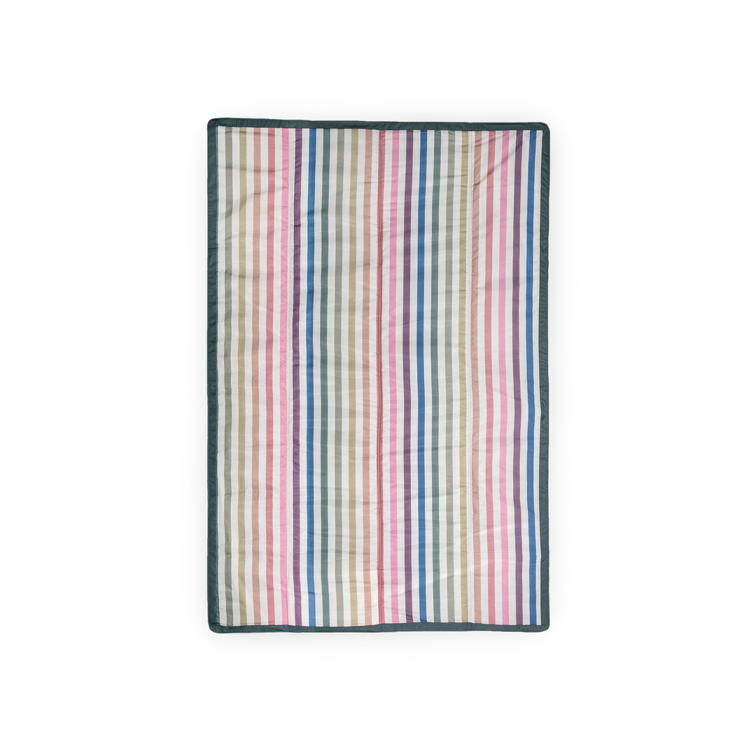Little Unicorn’s Chroma Rugby Stripe outdoor throw blanket, ideal for picnics, beach trips, and backyard adventures.